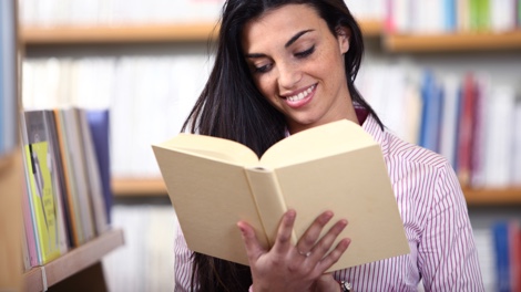 Student reads book in library